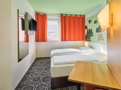 Ein Bett oder Betten in einem Zimmer der Unterkunft B&B Hotel Aschaffenburg