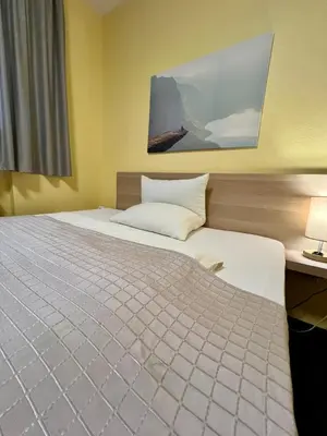Ein Bett oder Betten in einem Zimmer der Unterkunft Hotel Residenz Stockstadt