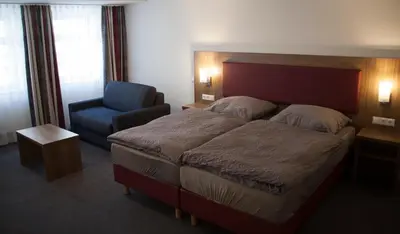 Ein Bett oder Betten in einem Zimmer der Unterkunft La Flamme Wertheim garni