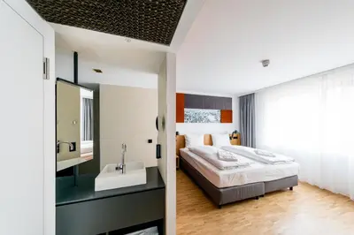 Ein Bett oder Betten in einem Zimmer der Unterkunft mk | hotel rüsselsheim