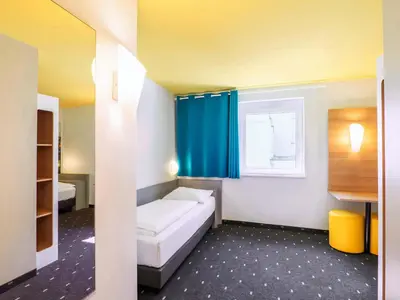 Ein Bett oder Betten in einem Zimmer der Unterkunft B&B Hotel Ludwigshafen