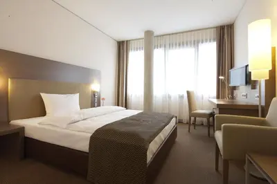 Ein Bett oder Betten in einem Zimmer der Unterkunft IntercityHotel Mannheim