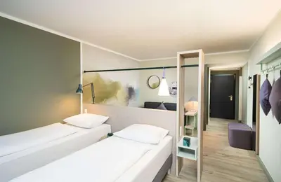 Ein Bett oder Betten in einem Zimmer der Unterkunft elaya hotel stuttgart ludwigsburg, Trademark by Wyndham