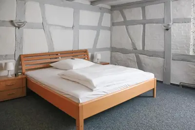 Ein Bett oder Betten in einem Zimmer der Unterkunft Hotel Haus Landgraf