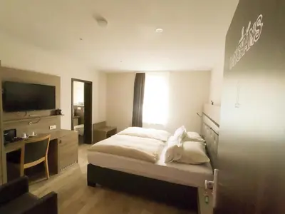 Ein Bett oder Betten in einem Zimmer der Unterkunft Hotel Langhans