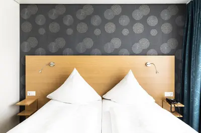 Ein Bett oder Betten in einem Zimmer der Unterkunft Hotel ISG Heidelberg