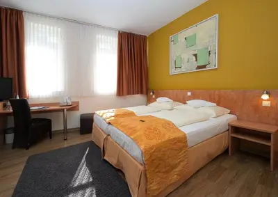 Ein Bett oder Betten in einem Zimmer der Unterkunft Hotel Alt Speyer