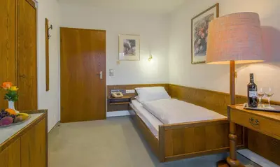 Ein Bett oder Betten in einem Zimmer der Unterkunft Hotel Schloessmann Garni