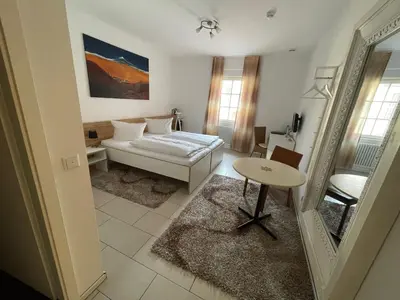 Ein Bett oder Betten in einem Zimmer der Unterkunft Landhotel Sickinger Hof