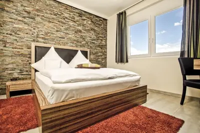 Ein Bett oder Betten in einem Zimmer der Unterkunft Hotel Maxis - digitaler Self-check-in -