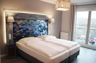 Ein Bett oder Betten in einem Zimmer der Unterkunft Winzerhotel Trautwein