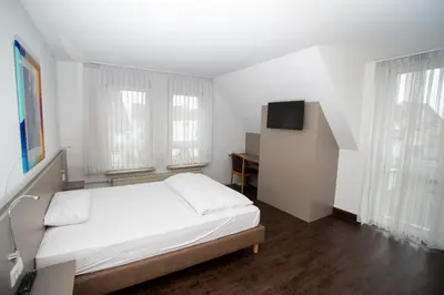 Ein Bett oder Betten in einem Zimmer der Unterkunft Hotel am Schillerplatz
