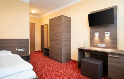 Ein Bett oder Betten in einem Zimmer der Unterkunft ates Hotel Lampertheim by AURUM