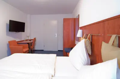 Ein Bett oder Betten in einem Zimmer der Unterkunft Hotel -Restaurant Taormina