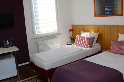Ein Bett oder Betten in einem Zimmer der Unterkunft Casa Hotel Neu-Isenburg