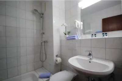 Ein Badezimmer in der Unterkunft Hotel Regina