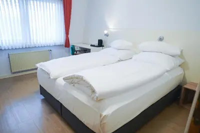 Ein Bett oder Betten in einem Zimmer der Unterkunft AP Hotel Mannheim Viernheim am Kapellenberg