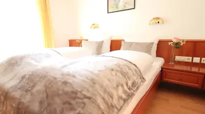 Ein Bett oder Betten in einem Zimmer der Unterkunft Hotel Kurparkblick inkl Therme und Sauna Eintritt