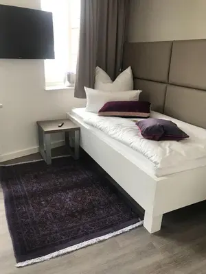 Ein Bett oder Betten in einem Zimmer der Unterkunft Trip Inn PostApart Aschaffenburg