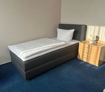 Ein Bett oder Betten in einem Zimmer der Unterkunft Hotel KM
