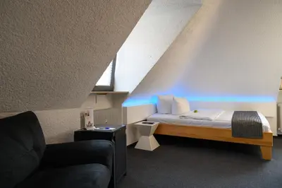 Ein Bett oder Betten in einem Zimmer der Unterkunft Hotel Heymann