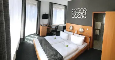 Ein Bett oder Betten in einem Zimmer der Unterkunft Hotel Heymann