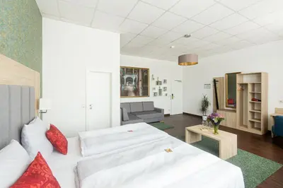 Ein Bett oder Betten in einem Zimmer der Unterkunft Pallas Hotel