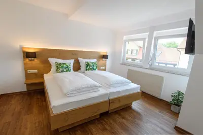 Ein Bett oder Betten in einem Zimmer der Unterkunft Zum Scheffelhof