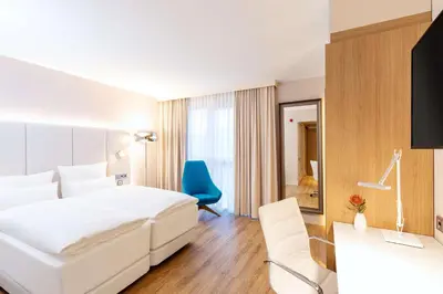 Ein Bett oder Betten in einem Zimmer der Unterkunft NH Mannheim