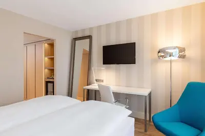 Ein Bett oder Betten in einem Zimmer der Unterkunft NH Mannheim