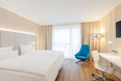 Ein Bett oder Betten in einem Zimmer der Unterkunft NH Mannheim