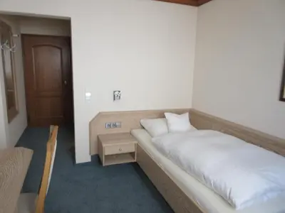 Ein Bett oder Betten in einem Zimmer der Unterkunft Häffner Bräu