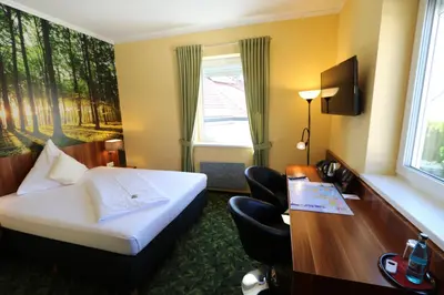Ein Bett oder Betten in einem Zimmer der Unterkunft Hotel Deutscher Hof