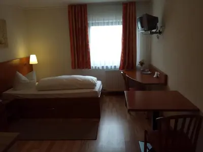 Ein Bett oder Betten in einem Zimmer der Unterkunft Hotel am Exerzierplatz