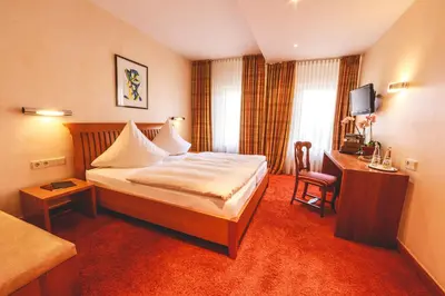 Ein Bett oder Betten in einem Zimmer der Unterkunft Hotel Löwen