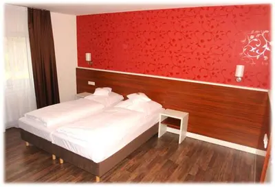 Ein Bett oder Betten in einem Zimmer der Unterkunft Brau Art Hotel