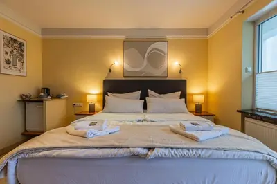 Ein Bett oder Betten in einem Zimmer der Unterkunft Gasper Business & Garden Hotel
