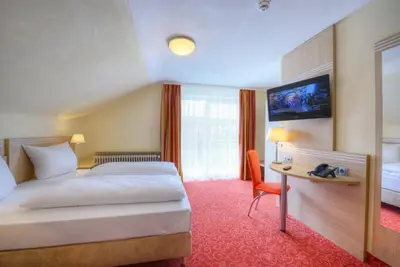 Ein Bett oder Betten in einem Zimmer der Unterkunft Gästehaus Deidesheim