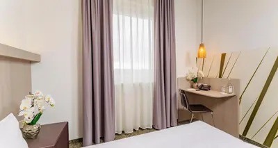 Ein Bett oder Betten in einem Zimmer der Unterkunft PLAZA INN Bad Rappenau