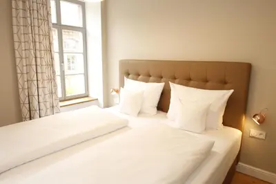 Ein Bett oder Betten in einem Zimmer der Unterkunft Amelie No 1 Hotel & Appartements