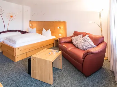 Ein Bett oder Betten in einem Zimmer der Unterkunft Hochwald Hotel & Apartment