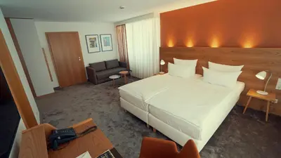 Ein Bett oder Betten in einem Zimmer der Unterkunft Hotel Adler Asperg