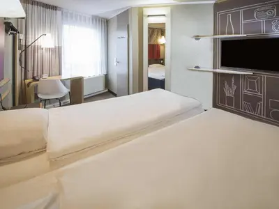 Ein Bett oder Betten in einem Zimmer der Unterkunft ibis Heidelberg Hauptbahnhof