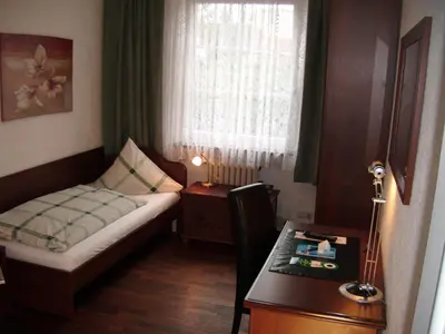 Ein Bett oder Betten in einem Zimmer der Unterkunft Isenburger Hof