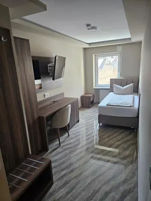 Ein Bett oder Betten in einem Zimmer der Unterkunft Hotel City Faber