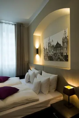 Ein Bett oder Betten in einem Zimmer der Unterkunft Hotel Residenz am Königsplatz