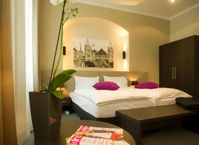 Ein Bett oder Betten in einem Zimmer der Unterkunft Hotel Residenz am Königsplatz