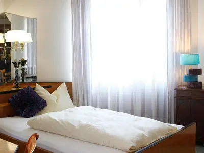 Ein Bett oder Betten in einem Zimmer der Unterkunft Hotel Villa Brenner