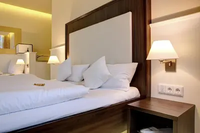 Ein Bett oder Betten in einem Zimmer der Unterkunft The Heidelberg Exzellenz Hotel