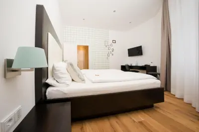 Ein Bett oder Betten in einem Zimmer der Unterkunft The Heidelberg Exzellenz Hotel